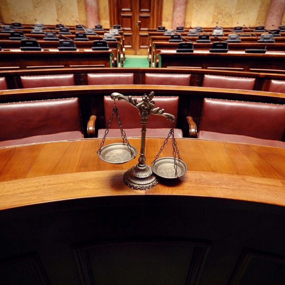A courtroom with a wooden table and chairs